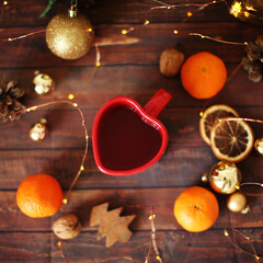 Christmas background cup, mandarins and garland. Preparation for holidays. Top view with copy space.