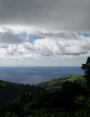 Typical landscape of Azores. Natural green fields hills and sea.