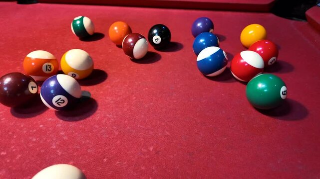 Colorful billiard balls on a red table evoke leisure and competition, perfect for game night concepts