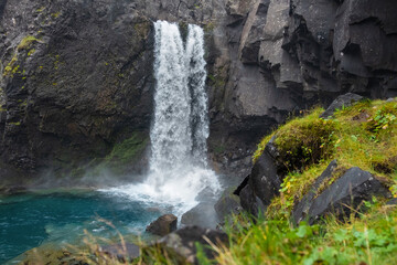River water stream from Icelandic cascade flowing over cliff.