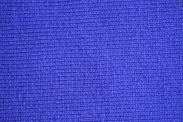 Macro texture of purple wool crochet sweater as background, close-up of purple crochet front surface, texture of woolen wool, crochet front surface