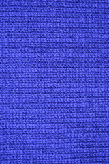 Macro texture of purple wool crochet sweater as background, close-up of purple crochet front surface, texture of woolen wool, crochet front surface