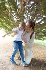 Fototapeta premium A woman and a child are standing in a forest