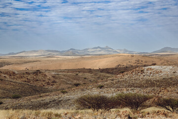 Exploring the breathtaking landscapes of Iona National Park in Angola during a clear day with distant mountains and rolling hills