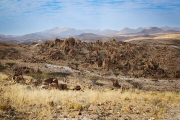 Exploring the rugged landscape of Iona National Park in Angola under a serene sky at midday