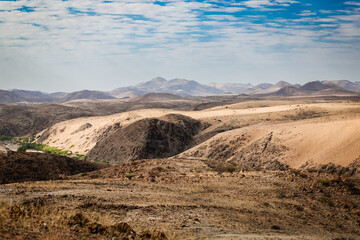 Vast landscapes of Iona National Park in Angola showcase dry terrain under a cloudy sky