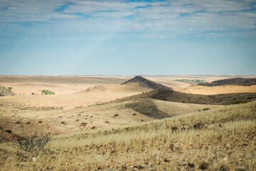 Vast landscapes of Iona National Park in Angola showcasing undulating hills and open skies during a sunny day
