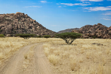 Exploring the rugged landscape of Iona National Park in Angola with rocky hills and sparse...