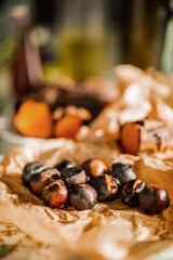 Roasted chestnuts on crumpled paper with blurred background