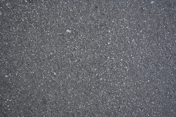 cracks on grey asphalt, repair of old road surface as background, wet pavement texture, gray asphalt texture with red and white gravels	
