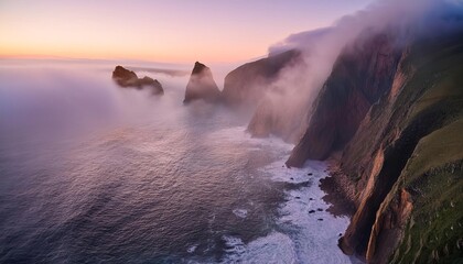 Fog is covering the steep cliffs at sunset on the coastline