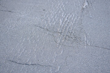 Cracks on grey asphalt close-up, old cracked asphalt close-up, old road surface bitumen  