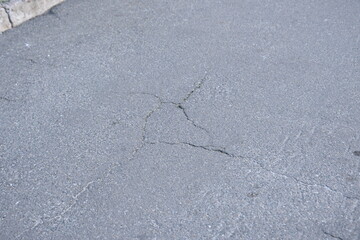 Cracks on grey asphalt close-up, old cracked asphalt close-up, old road surface bitumen  