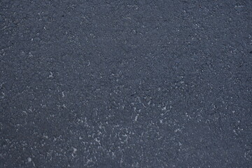 dark grey and light grey asphalt, junction of new and old road surfaces, repaired roadway