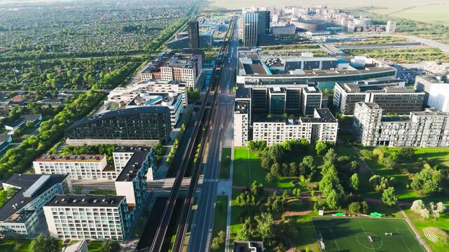 Scenic aerial view over Orestad metro line in green residential area, Denmark
