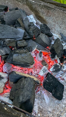 Glowing hot charcoal briquettes in a barbecue grill, symbolizing summer barbecues and outdoor cooking during Memorial Day celebrations
