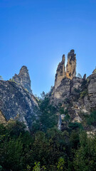 Majestic rock formations under a clear blue sky in Meteora, Greece, ideal for promoting travel and adventure tourism