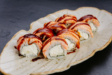Delicious salmon sushi rolls with cream cheese and sweet soy glaze, Japanese inspired meal
