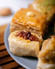 Assorted Turkish baklava pastries on a plate, perfect for Eid celebrations, showcase a rich cultural dessert tradition