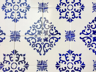 Blue and white intricate ceramic tiles featuring elegant Portuguese azulejo patterns, symbolizing cultural heritage and decorative artistry