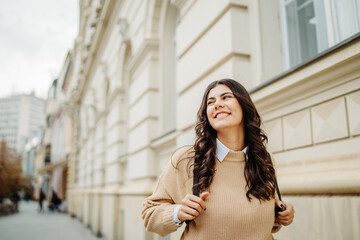 Fototapeta premium Young caucasian smiling woman student going to university 