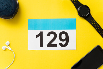 Aerial photograph of part of a team to run a race on a yellow background.Running bib with running materials.Race team concept.