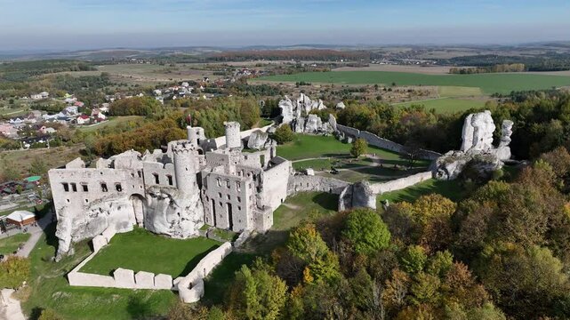 Aerial drone view of medieval castle Ogrodzieniec in Poland. Strongholds Eagles Nests in Polish Jurassic Highland in Silesia. Limestone rock castle ruins. Ogrodzieniec, Podzamcze castle in autumn.