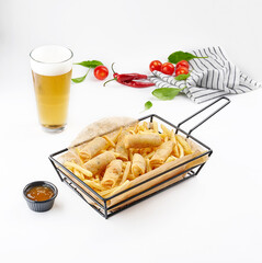 Basket fried chips and pastry with sauce basket style.