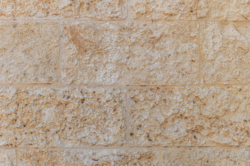 abstract background of beige stone lined old wall close up