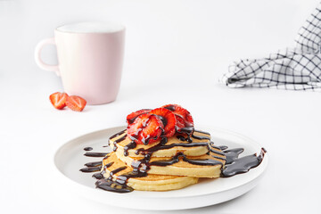 Pancake is in the plate, chocolate, strawberry, coffee isolated style white background.