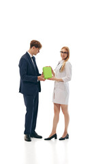 Doctor handing over green box to businessman, representing healthcare delivery and partnership between medical professionals and businesses. Health product promotions. Concept of medicine, health