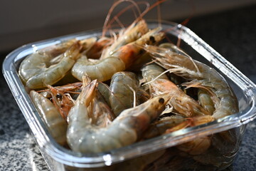 shrimp, carcasses of fresh grey thawed shrimp close up, shrimp tails fresh for cooking 