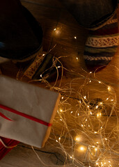 Cozy legs beside holiday presents and garland
