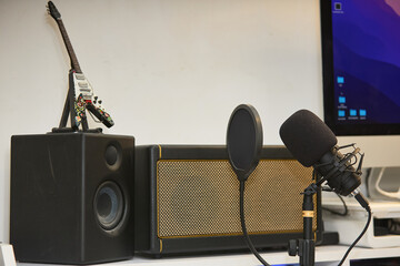 broadcaster's workstation with microphone, anti-pop filter and other studio equipment