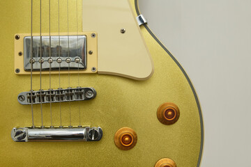 Close-up photograph of a vintage gold-plated electric guitar, details