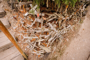 Wooden crosses and rosaries pile up on the ground at the Hill of Crosses, a significant religious...
