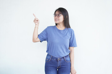 Beautiful Asian woman smiles while pointing to the side copy space, perfect for advertising or promotions on a white background
