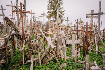 A large collection of wooden crosses, crucifixes, and rosaries displayed at Kryžių Kalnas (Hill...