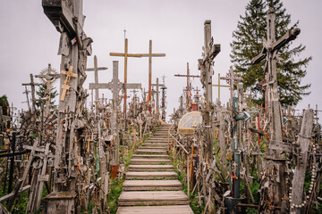 A large collection of wooden crosses, crucifixes, and rosaries displayed at Kryžių Kalnas (Hill...