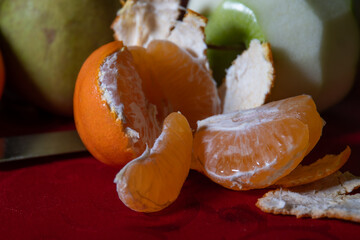 peeled mandarine with apple and pear
