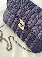 Trendy woman bag on light background. Fashionable feminine handbag