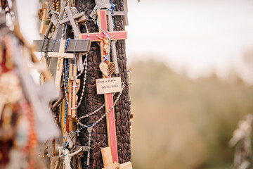 A large collection of wooden crosses, crucifixes, and rosaries displayed at Kryžių Kalnas (Hill...