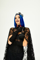 Naklejka premium A beautiful young woman showcases her Halloween costume, exuding elegance and mystery with her look.