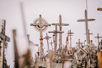 A large collection of wooden crosses, crucifixes, and rosaries displayed at Kryžių Kalnas (Hill...
