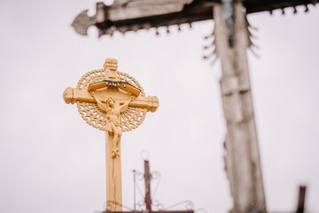 A large collection of wooden crosses, crucifixes, and rosaries displayed at Kryžių Kalnas (Hill...
