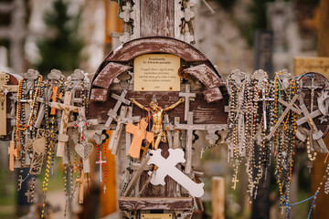 A large collection of wooden crosses, crucifixes, and rosaries displayed at Kryžių Kalnas (Hill...