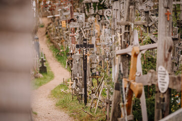 A large collection of wooden crosses, crucifixes, and rosaries displayed at Kryžių Kalnas (Hill...