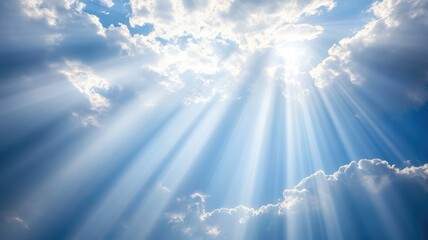 Fototapeta premium Sun rays break through clouds in bright blue sky