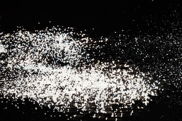 Abstract black and white background of pouring flour, space for text