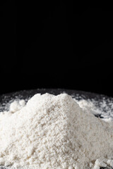Close-up of natural coconut flour on a black background